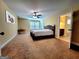 Spacious bedroom with carpet, ceiling fan, window and doorway to bathroom and vanity at 180 Oakland Hills Way, Lawrenceville, GA 30044