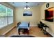 View of the dining area featuring a wood table and chairs with a large window bringing in ample light at 180 Oakland Hills Way, Lawrenceville, GA 30044
