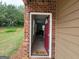 Inviting front door entrance with a red door and 'hello' welcome mat on a light tile floor at 180 Oakland Hills Way, Lawrenceville, GA 30044
