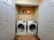 A closet style laundry room with side-by-side washer and dryer at 180 Oakland Hills Way, Lawrenceville, GA 30044