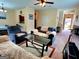 Bright living room with a comfortable seating arrangement, glass table, and carpeted floors at 180 Oakland Hills Way, Lawrenceville, GA 30044