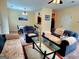 Open living space featuring comfortable sofas, a glass coffee table, and carpeted floors at 180 Oakland Hills Way, Lawrenceville, GA 30044