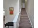 Carpeted stairway leading to the upper level, featuring a white railing and neutral wall colors at 180 Oakland Hills Way, Lawrenceville, GA 30044