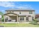 Exterior view of the home's backyard with a covered patio, grill, and a basketball hoop at 230 Haleys Ct, Woodstock, GA 30188
