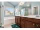 Bright bathroom featuring double vanity, soaking tub, and modern fixtures with natural light at 230 Haleys Ct, Woodstock, GA 30188