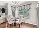 Bright breakfast nook with hardwood floors, elegant window treatments, and comfortable seating at 230 Haleys Ct, Woodstock, GA 30188