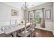Dining room featuring hardwood floors, wainscoting and a decorative chandelier at 230 Haleys Ct, Woodstock, GA 30188