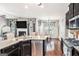 Open concept kitchen with granite counters, stainless steel appliances, and view of dining area at 230 Haleys Ct, Woodstock, GA 30188