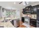 Bright kitchen with stainless steel appliances, dark cabinets, and a cozy dining area at 230 Haleys Ct, Woodstock, GA 30188