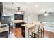 Open kitchen with dark cabinets, granite countertops, stainless steel appliances, and a breakfast bar at 230 Haleys Ct, Woodstock, GA 30188