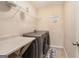 Functional laundry room with modern washer and dryer units and ample counter space at 230 Haleys Ct, Woodstock, GA 30188