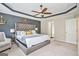 Spacious main bedroom with a tray ceiling, a decorative headboard, and plush carpeting at 230 Haleys Ct, Woodstock, GA 30188