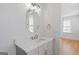Contemporary bathroom featuring a white vanity with marble countertop and framed mirror at 915 Laurel Brooke Ave, Peachtree City, GA 30269