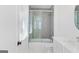 Modern bathroom featuring a glass-enclosed tub and shower and white vanity at 915 Laurel Brooke Ave, Peachtree City, GA 30269