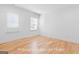 Bright bedroom features hardwood floors and natural light streaming through the window at 915 Laurel Brooke Ave, Peachtree City, GA 30269