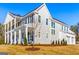 Exterior showing an ample sized lawn, front porch, attached garage, and gray siding at 915 Laurel Brooke Ave, Peachtree City, GA 30269