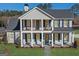 Charming two-story home boasts classic curb appeal with a welcoming front porch and well-manicured lawn at 915 Laurel Brooke Ave, Peachtree City, GA 30269