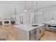 Open-concept kitchen with a large center island, stainless steel appliances, and hardwood flooring at 915 Laurel Brooke Ave, Peachtree City, GA 30269