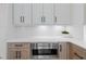 Close up of the kitchen featuring built in microwave, light countertops and wooden cabinets at 915 Laurel Brooke Ave, Peachtree City, GA 30269