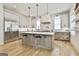 Beautiful kitchen boasts a large island, stainless steel appliances, and modern pendant lighting at 915 Laurel Brooke Ave, Peachtree City, GA 30269