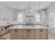 Gorgeous kitchen with a large center island, wooden cabinets, and modern stainless appliances at 915 Laurel Brooke Ave, Peachtree City, GA 30269