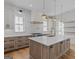 A spacious kitchen features light countertops, hardwood flooring, and wooden cabinetry at 915 Laurel Brooke Ave, Peachtree City, GA 30269