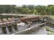 Scenic view of Lake Peachtree dam, bridge, and surrounding greenery at 915 Laurel Brooke Ave, Peachtree City, GA 30269
