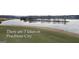 There are 3 lakes in Peachtree City; peaceful lake view with grassy shoreline at 915 Laurel Brooke Ave, Peachtree City, GA 30269