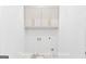 Neat laundry room with white cabinets and plenty of space for appliances at 915 Laurel Brooke Ave, Peachtree City, GA 30269