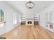 Spacious living room with hardwood floors, a fireplace, built-in shelves, and natural light at 915 Laurel Brooke Ave, Peachtree City, GA 30269
