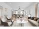 Open-concept living area showcasing hardwood floors, kitchen, dining table, and ample seating at 915 Laurel Brooke Ave, Peachtree City, GA 30269