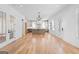 Open living space featuring hardwood floors, modern lighting, and a view into the kitchen at 915 Laurel Brooke Ave, Peachtree City, GA 30269