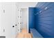 Welcoming mudroom featuring blue accent wall and bench at 915 Laurel Brooke Ave, Peachtree City, GA 30269