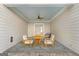 Covered patio features slate flooring, outdoor furniture, and a ceiling fan at 915 Laurel Brooke Ave, Peachtree City, GA 30269