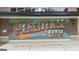 Colorful 'Greetings from Peachtree City' mural on a brick building at 915 Laurel Brooke Ave, Peachtree City, GA 30269