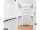 Spacious walk-in closet with custom shelving, rod and a wooden ladder for easy access at 915 Laurel Brooke Ave, Peachtree City, GA 30269