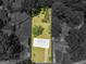 Aerial view of a single-story home with a spacious yard, surrounded by lush trees and neighboring houses at 3548 Meadowview Ct, Rex, GA 30273