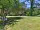 Relaxing backyard featuring a cozy swing under mature trees, perfect for outdoor enjoyment at 3548 Meadowview Ct, Rex, GA 30273