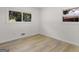 A bright bedroom features two large windows and contemporary floors at 3548 Meadowview Ct, Rex, GA 30273