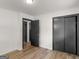 Bedroom featuring wood flooring and dark closet doors at 3548 Meadowview Ct, Rex, GA 30273
