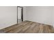Bedroom featuring new floors and fresh paint, with doorway to additional room at 3548 Meadowview Ct, Rex, GA 30273