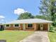 Traditional brick home with a well-kept lawn, inviting entryway, and convenient covered carport at 3548 Meadowview Ct, Rex, GA 30273