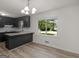 Kitchen featuring sleek black cabinets, granite countertops, and a bright window at 3548 Meadowview Ct, Rex, GA 30273