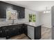 Well-lit kitchen features black cabinets, subway tile backsplash, and granite countertops at 3548 Meadowview Ct, Rex, GA 30273
