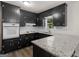 Kitchen featuring black cabinets, granite counters, and stainless steel sink at 3548 Meadowview Ct, Rex, GA 30273