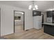Open kitchen and dining area featuring new floors, and black cabinets at 3548 Meadowview Ct, Rex, GA 30273