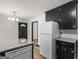 Bright kitchen features white appliances, granite countertops, and stylish lighting at 3548 Meadowview Ct, Rex, GA 30273