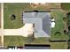 Aerial view of a home featuring a large driveway, well-maintained lawn, and patio seating area at 127 Laurel Springs Dr, Mcdonough, GA 30253