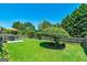 Lush backyard featuring a manicured lawn, mature trees, and an outdoor seating area at 127 Laurel Springs Dr, Mcdonough, GA 30253