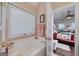 Bright bathroom featuring a soaking tub and views into the main bedroom at 127 Laurel Springs Dr, Mcdonough, GA 30253